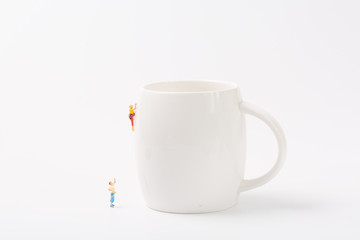 Man climbing cup on white background