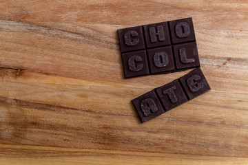 Fototapeta na wymiar Chocolate bar on wooden cutting board. Mexican traditional sweet