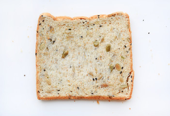 Sliced whole grain bread with seeds isolated on white background. Top view.