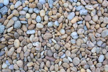 Color pebble stone on ground for texture background.