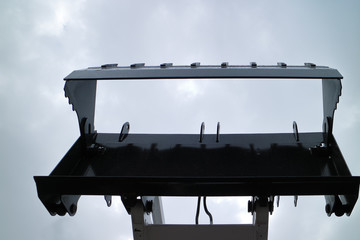 Picture of a universal bucket of a bulldozer-loader in the open position.
