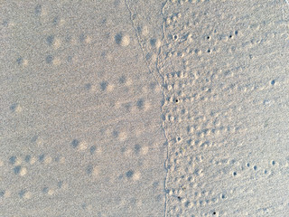 Circle and hole pattern in sand  beach texture, Crab nest, Abstract background concept