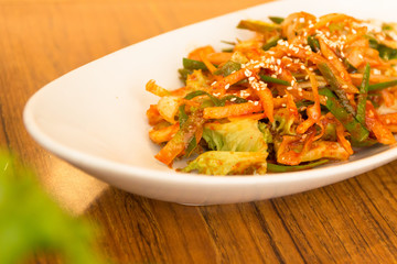 Kimchi made with bunching onion and bean sprouts, is a traditional fermented Korean side dish made of vegetables with a variety of seasonings (Pa Kimchi)