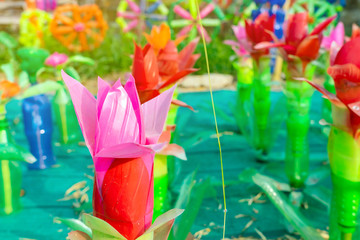 Fototapeta premium Recycled colorful plastic flowers made from plastic bottles to decorate as flowers in the garden. Plastic bottle recycled.