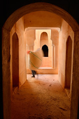 Worker carrying feed to dry in Kasbah Ait Mouted in Dades Gorge Morocco