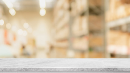 Empty white mable stone table top and blurred bokeh warehouse interior space  background - can used...