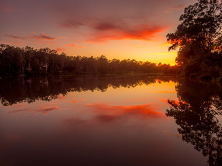 Fototapeta na wymiar Colourful River Sunrise with Reflections