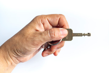 Woman's left hand use a key for lock or unlock in white background, Close up & Macro shot, Selective focus, Security concept