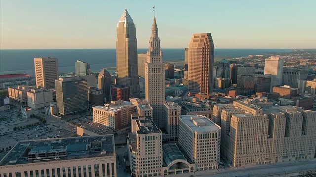Aerial flying over downtown Cleveland city skyline at sunset, Ohio, USA