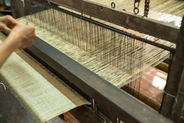 Weaving silk in traditional way in Vietnam. Vietnamese silk processing.