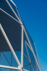 Close up view of glass dome side triangle structure. Modern architectural exterior fragment.