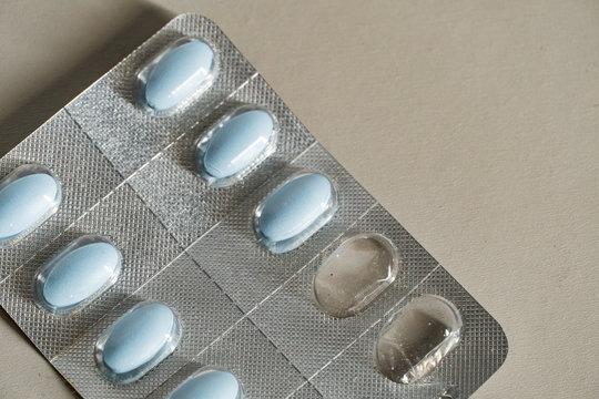 Close up view of blue pills in blister package isolated. 