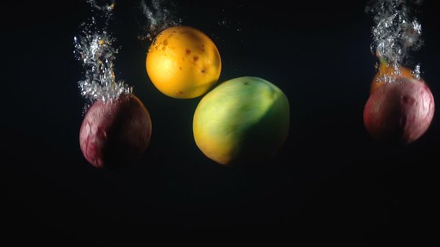 Footage of falling mango and maracuya in the water