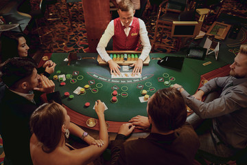 Top view group of young people gambling casino.