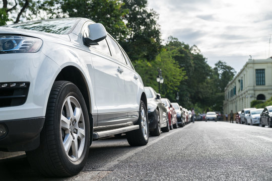 Parallel parking cars on urban street. Outdoor parking on road
