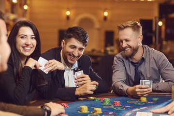 A group of wealthy young people gamble at a casino. - Powered by Adobe