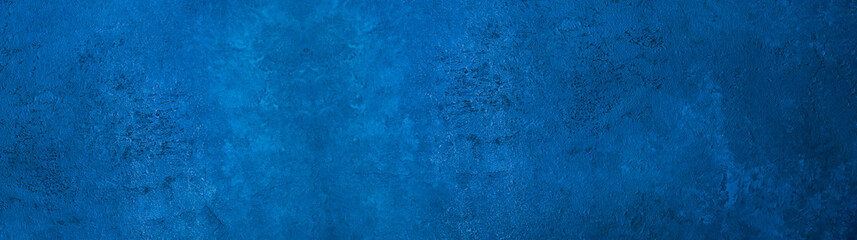 Dark slate background toned classic blue color. Long banner. Old textured background