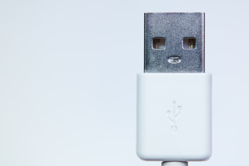 The face of usb cord head like a live robot on a white background close up