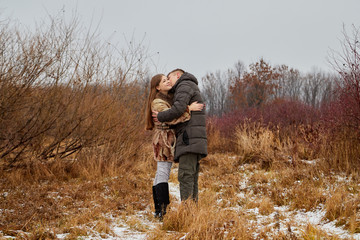 Naklejka na ściany i meble Romantic couple in love on autumn or winter walk