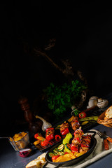 Shish kebab with various vegetables and spice country potatoes