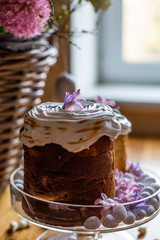 vertical close-up photo of Easter cake on wicker basket background