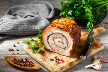 Meatloaf with vegetables and herbs on a wooden Board on a gray wooden table. Baked meat. Top view with space for text. Vertical orientation. Rustic style
