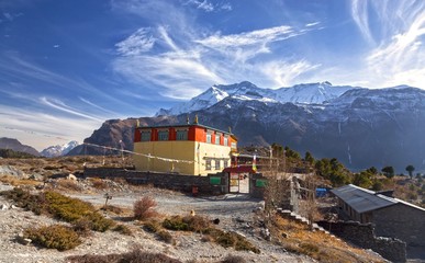 Lophelling Buddhist Monastery Exterior and Distant Snowcapped Annapurna Range Mountain Peaks Landscape View in Nepal Himalayas