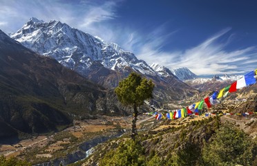 Landscape View of Annapurna 3 Peak (7555 m) in Himalaya Mountain Range and Buddhist Prayer Flags on Annapurna Circuit Trekking Route in Nepal - obrazy, fototapety, plakaty