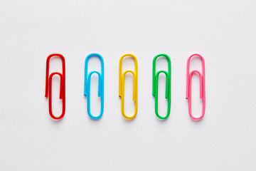 Variety of colorful paper clips in a row