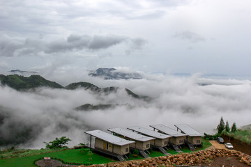The view of the natural background of the mountain close-up, with blurred fog scattered in the rainy season or the humid climate, with beautiful green trees in the ecological system