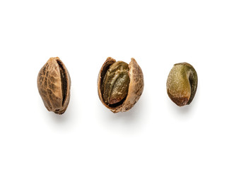 Creative layout of hemp seeds. Superfood hemp concept. Top view of three cannabis or hemp seeds in...
