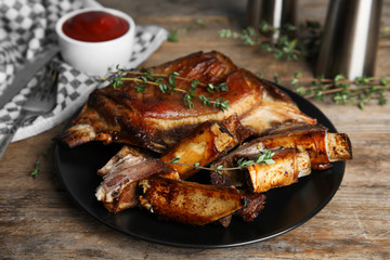 Delicious roasted ribs served on wooden table