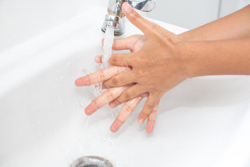 Hygiene concept. Washing hands with soap under the faucet with water