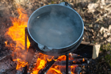 The cauldron on the fire the view from the top, boiling water in the pot,