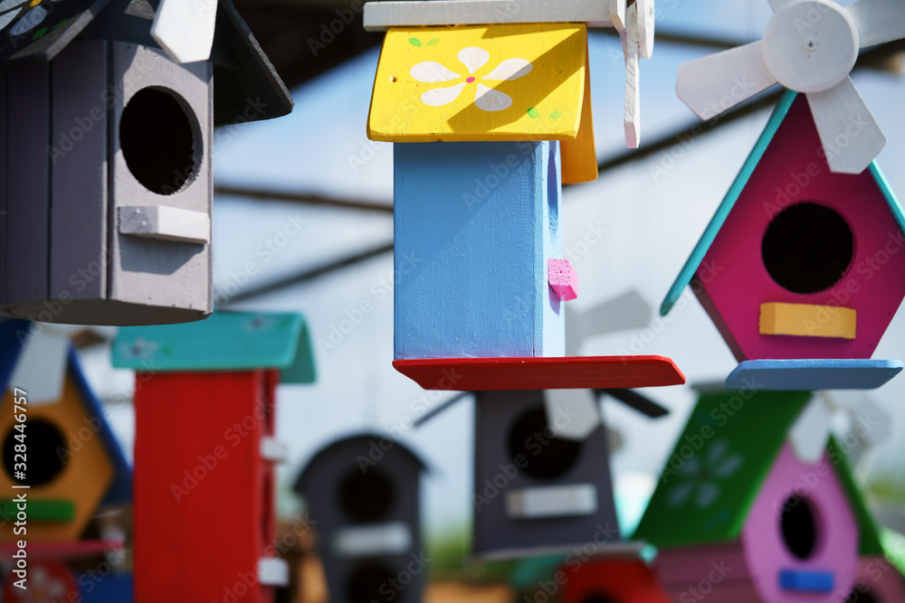 Poster close up of beautiful colored wooden bird house