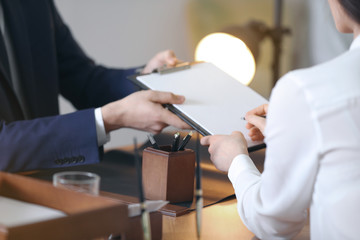 Male lawyer working with client in office, closeup