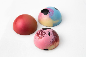 Colorful modern chocolate bonbon truffles on marble