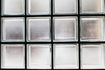 glass cubes block wall for background.Modern architecture detail.It can be used as background for graphic work.Square transparent glass block wall interior design for home or building decoration. allo