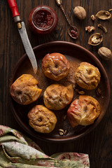 Baked apples with cinnamon, icing sugar and nuts. Home cooking.