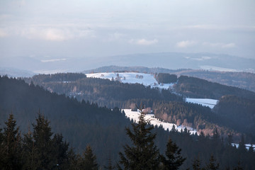 Czarna Góra peak in Sudety mountains ski route far view in the snow on beautiful morning sun scene