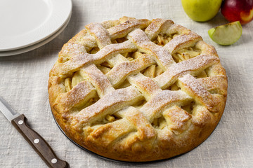 Popular American apple pie on gray table background. Homemade classical fruit tart. Copy space