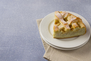 Popular American apple pie on gray table background. Homemade classical fruit tart. Copy space