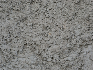 gray wall covered with rough plaster, rough wall surface texture