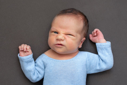 Newborn Baby Emotions, White Background. Funny Face Of A Child, Emotions.