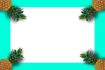 Flat layout pineapple for summer seasonal concept. Ripe yellow pineapples on soft blue background decorated with blank copy space.