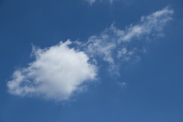 Fototapeta premium White cloud formation isolated against a bright blue sky image for background use with copy space