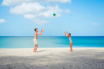 children play ball on the beach