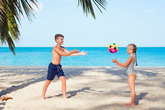 children play ball on the beach