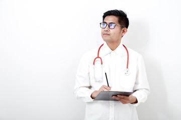 Fototapeta premium Male doctor writes on the document clipboard