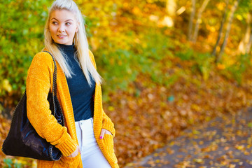 Fashion woman walking in autumn park